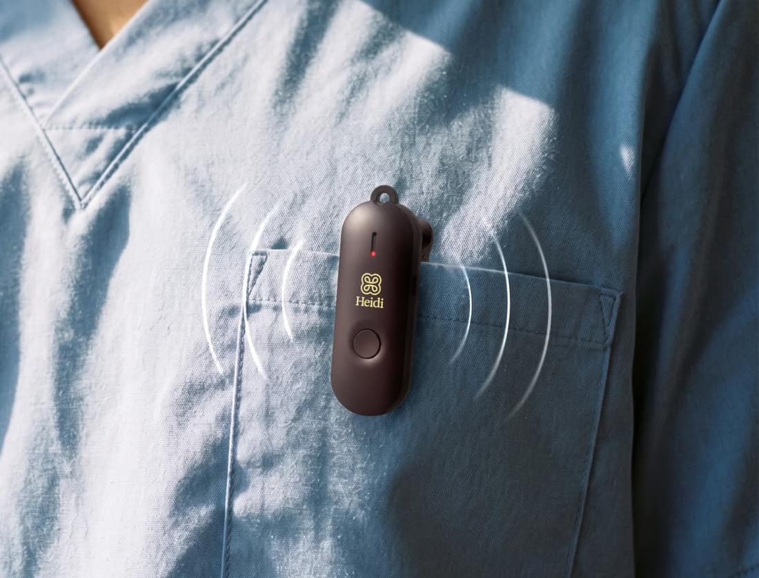 A clinician with the Heidi voice-capture device clipped to their scrubs pocket